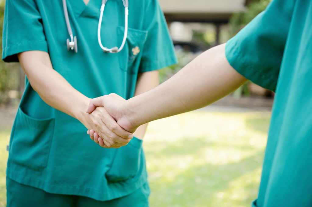 Nurses shaking each other's hands